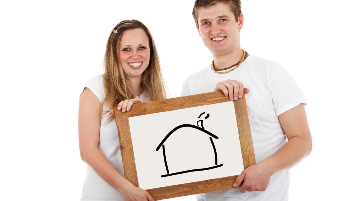 Couple holding house white board