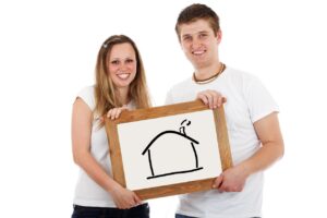 Couple holding house white board